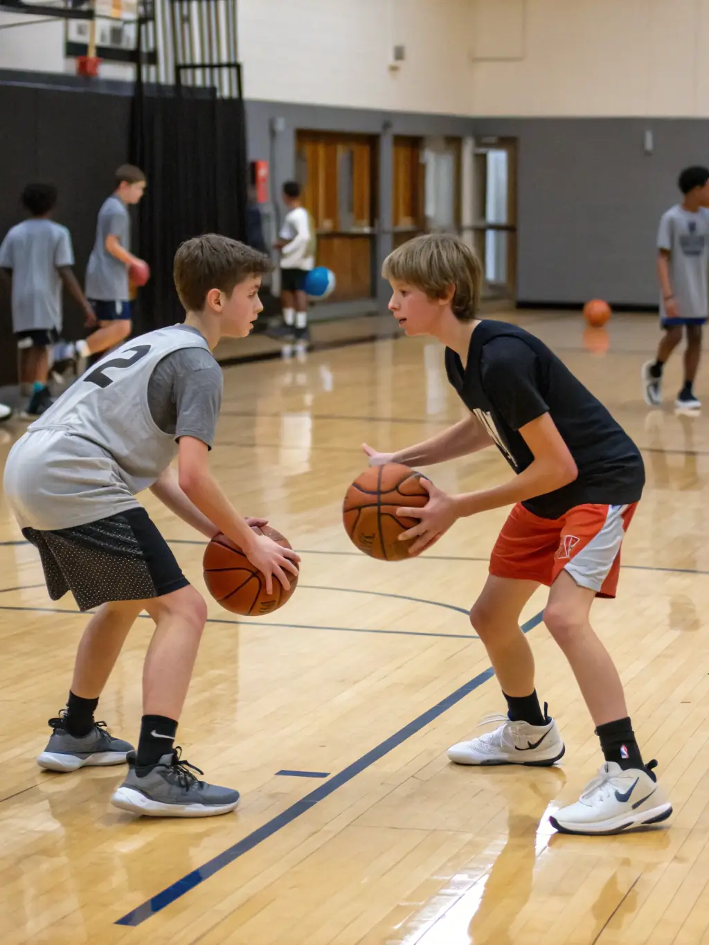 A group of young basketball players in OGS uniforms practicing dribbling drills during a training session, showcasing their focus and determination.