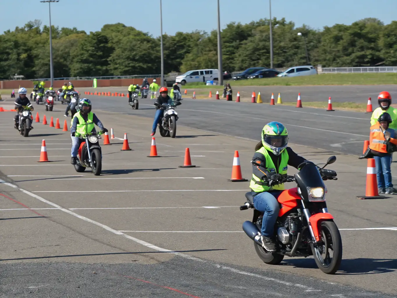 A group of motorcyclists participating in a safety training session, focusing on proper riding techniques and hazard awareness.